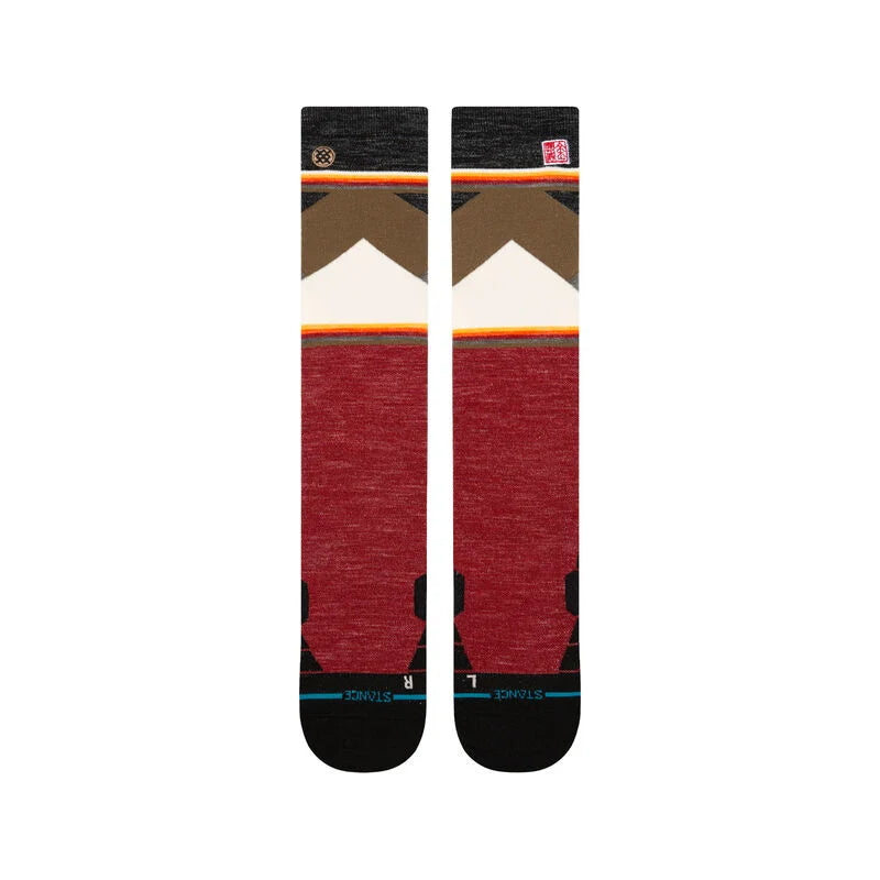 Stance X Jimmy Chin Snow Sock 2025 - A pair of snow socks with a brown and tan chevron pattern at the top, featuring a white mountain peak in the center.