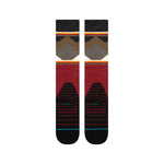 Stance X Jimmy Chin Snow Sock 2025 - A pair of snow socks with a brown and gray geometric pattern on top, red at the bottom, and black toes.