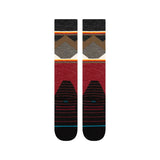 Stance X Jimmy Chin Snow Sock 2025 - A pair of snow socks with a brown and gray geometric pattern on top, red at the bottom, and black toes.