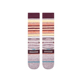 Stance Curren Snow Sock 2025 - A pair of snow socks with a predominantly white base, featuring horizontal stripes in shades of orange and yellow at the top, and thin blue lines near the toes.