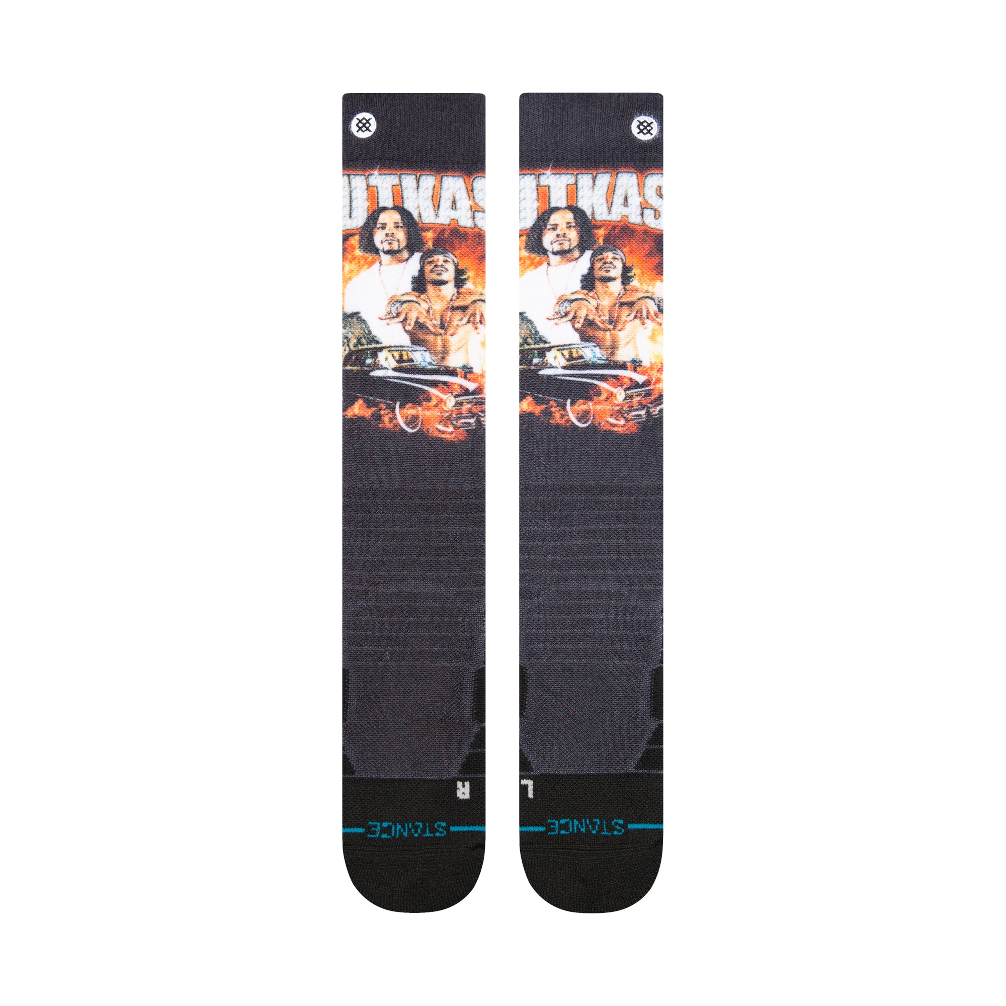 Stance X Outkast Snow Sock 2025 - A pair of black snow socks with a repeating pattern featuring three men from the hip-hop group OutKast, wearing white shirts and gold chains, set against an orange background.