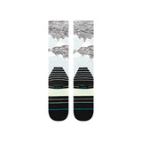 Stance Windy Peaks Snow Sock 2025 - A pair of snow socks with a light blue background and dark gray mountains in the center, featuring white lines that resemble wind patterns.