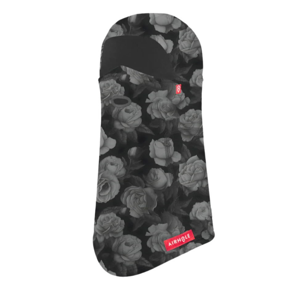 Airhole Hinge Polar Balaclava - A black balaclava with a repeating pattern of white roses and leaves, featuring a red logo on the left side.