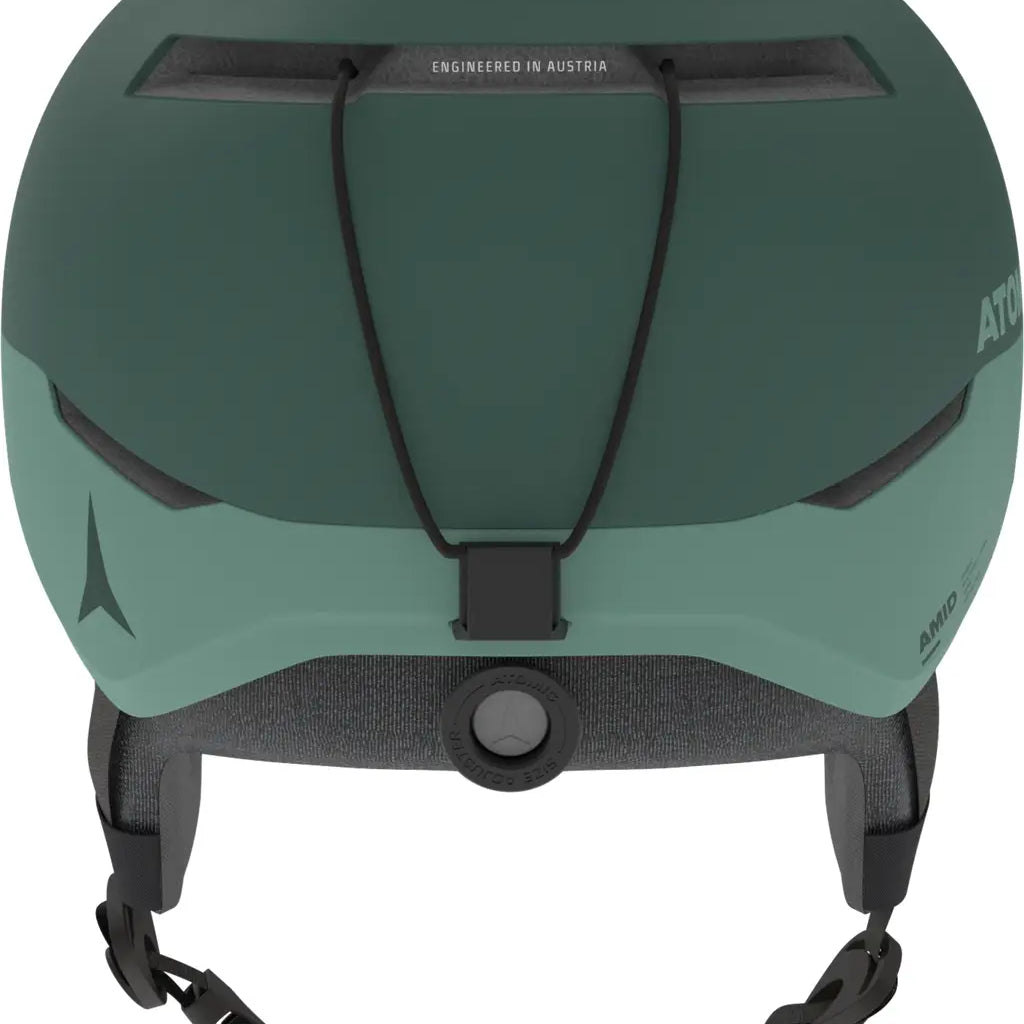 Atomic Four Amid Helmet 2025 - A dark green helmet with a matte finish, featuring a black chin strap and a small logo on the side.