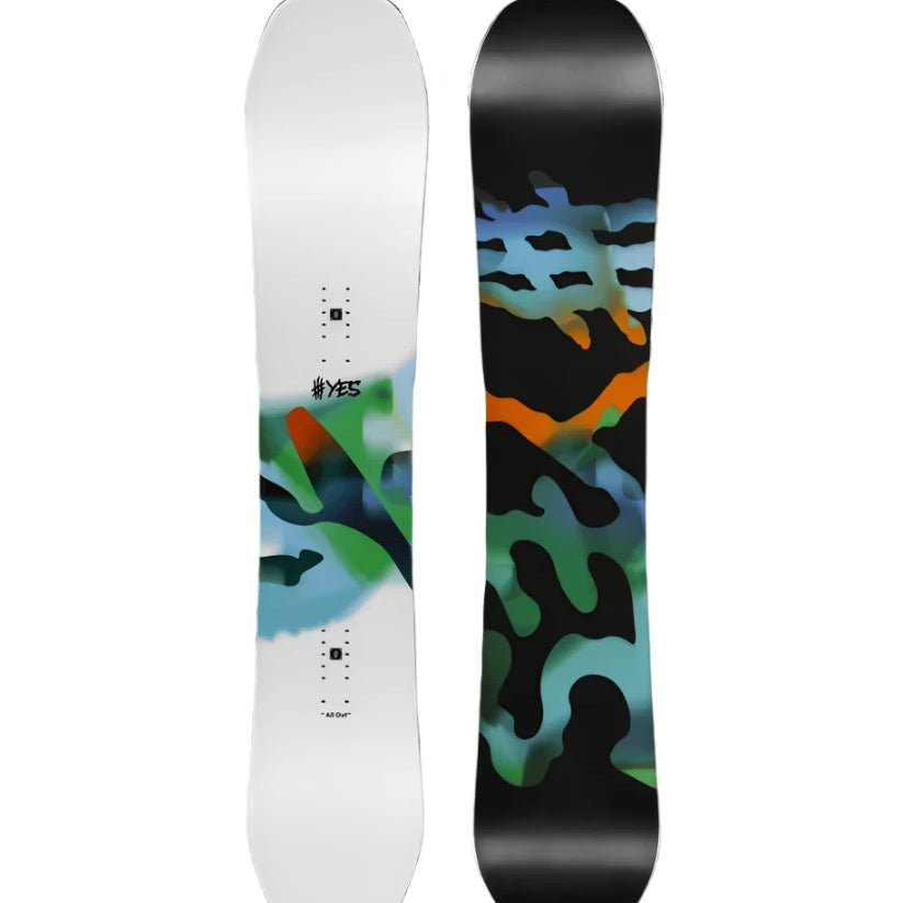 The Yes brand All-Out snowboard from 2025 has a black top sheet with green and orange abstract design, featuring a twin tip shape.