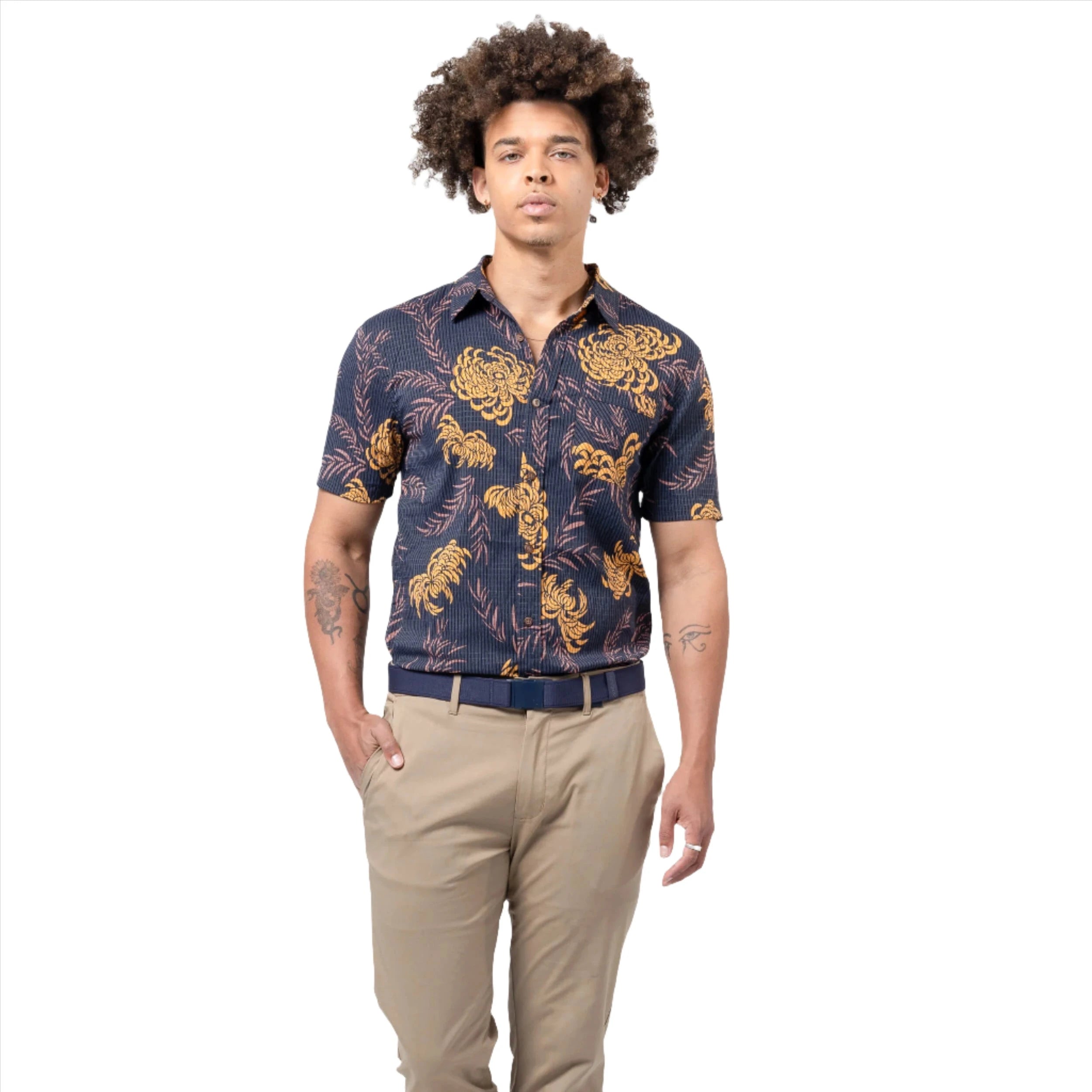 A person wearing a navy blue belt with khaki pants and a dark blue shirt with orange floral patterns. The belt is fastened around the waist.