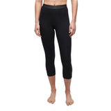 Le Bent Women's Core Lightweight 3/4 Bottom Base Layer - A pair of black women's leggings with a high waistband and three-quarter length, featuring a subtle logo on the left leg.