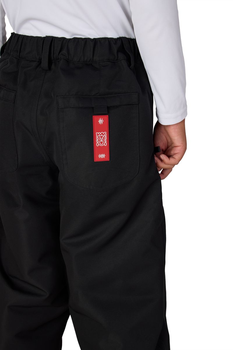 Black boys' shell pants with elastic waist and red logo patch on pocket