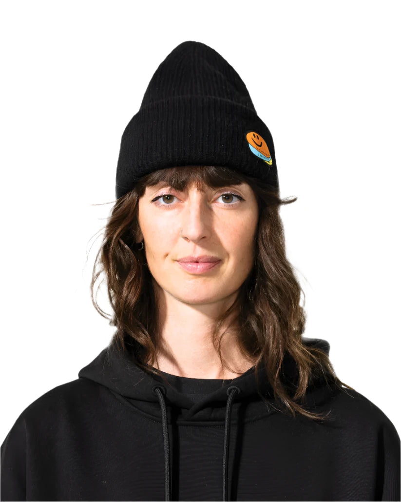 Bataleon 2 Way Beanie 2025 - A black beanie with a small orange smiley face logo on the front left side.