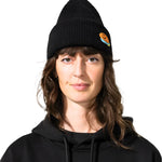 Bataleon 2 Way Beanie 2025 - A black beanie with a small orange smiley face logo on the front left side.
