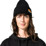Bataleon 2 Way Beanie 2025 - A black beanie with a small orange smiley face logo on the front left side.