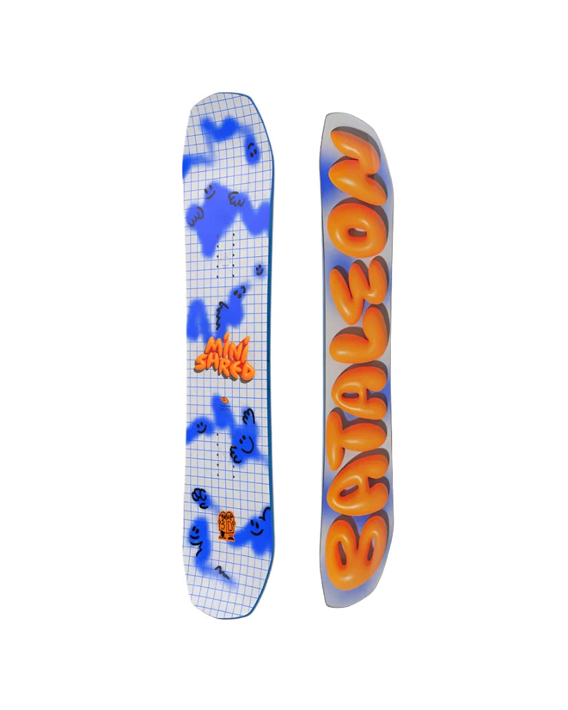 Bataleon Junior's Minishred Snowboard 2025 - A blue and white snowboard with a grid pattern on its top surface, featuring black smiley faces and question marks scattered throughout.