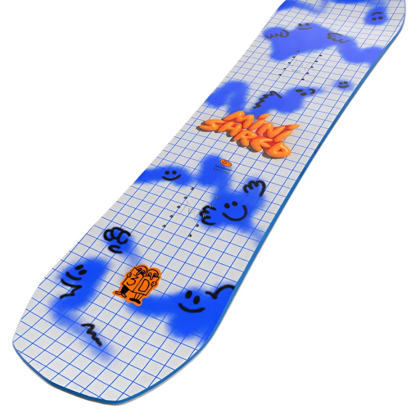 Bataleon Junior's Minishred Snowboard 2025 - A white snowboard with blue grid pattern and black smiley faces, featuring a small orange cartoon character in the bottom left corner.