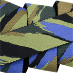 Arcade Brushstroke Stretch Belt 2025 - A belt with a blue, green, and black brush stroke pattern on a dark gray background.