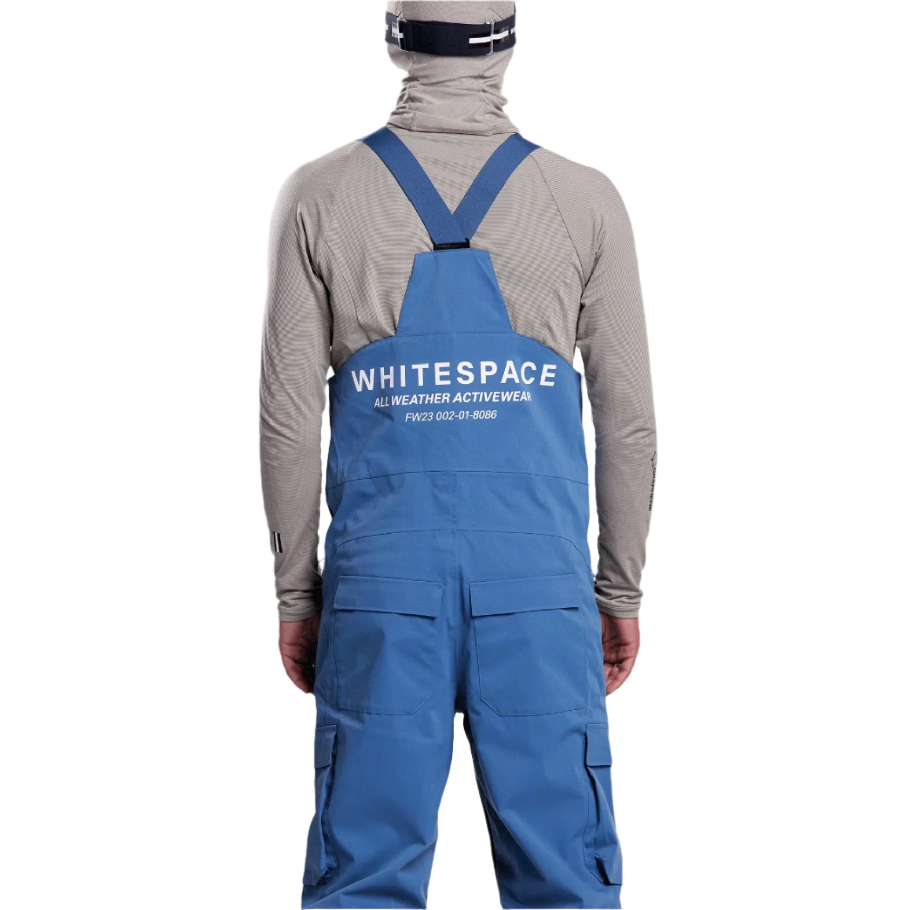 Whitespace 2L Cargo Insulated Bib Pants 2024 - A pair of blue bib pants with cargo pockets on each thigh and a white logo on the left leg.