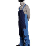 Whitespace 2L Cargo Insulated Bib Pants 2024 - A pair of dark blue snow pants with cargo pockets on each thigh and a black zipper at the ankle.