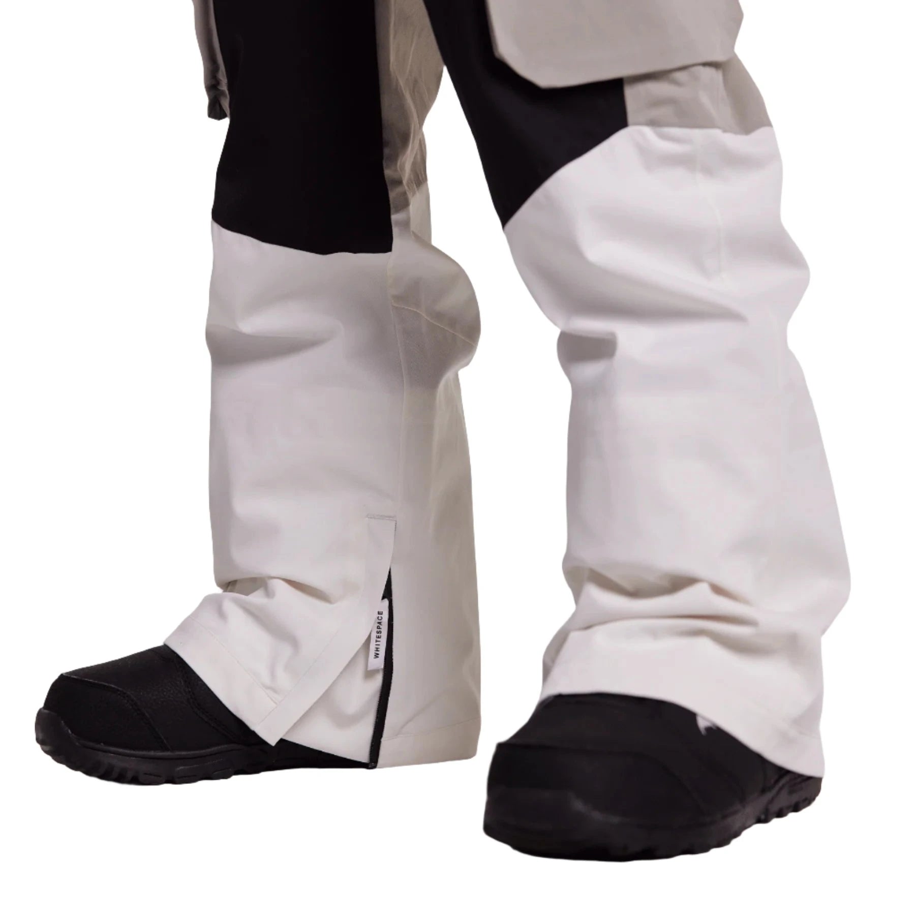 Whitespace 2L Cargo Insulated Bib Pants 2024 - A pair of white snow pants with black cargo pockets on each thigh and a black waistband.