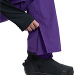 Burton Covert 2.0 2L Pants 2025 - Dark purple snow pants with a zippered pocket on the right thigh and adjustable Velcro straps at the ankles.