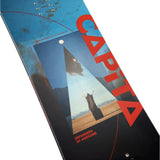 CAPiTA Defenders Of Awesome Snowboard 2025 - A blue snowboard with a triangular graphic featuring a person in a black robe standing on top of a mountain, wearing a pointed hat and holding a staff.