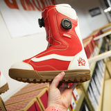 Vans Women's Encore Pro Limited Edition Snowboard Boots 2026 - A pair of red snowboard boots with white accents and a black BOA dial on the side.