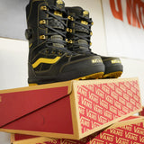 Vans Invado Pro Limited Edition Snowboard Boots 2026 - Black boots with yellow accents and stitching, featuring a distinctive wavy logo on the side.