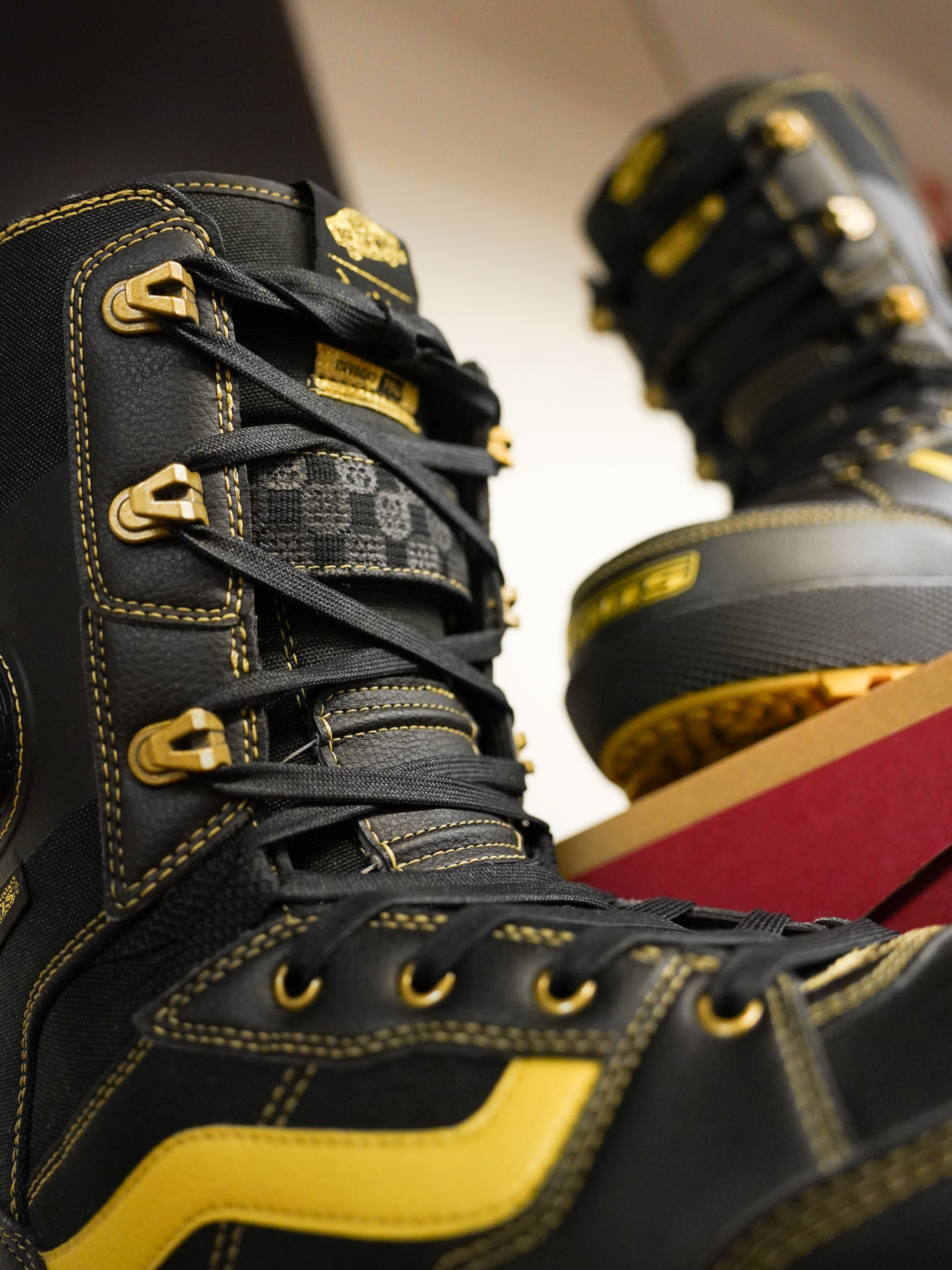 Vans Invado Pro Limited Edition Snowboard Boots 2026 - Black snowboard boots with yellow accents and gold buckles.
