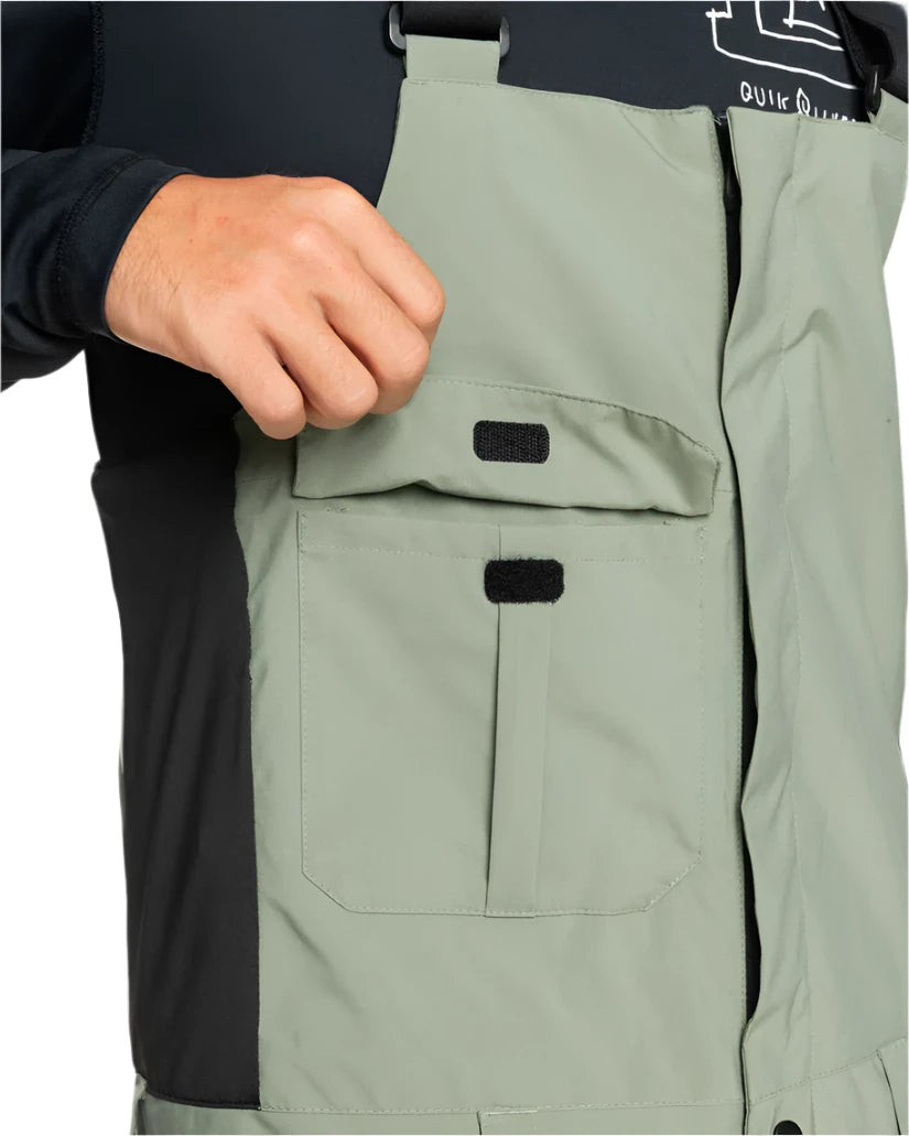 Quiksilver Utility Shell Bib 2025 - A sage green bib with two front pockets and a black logo on the left leg.