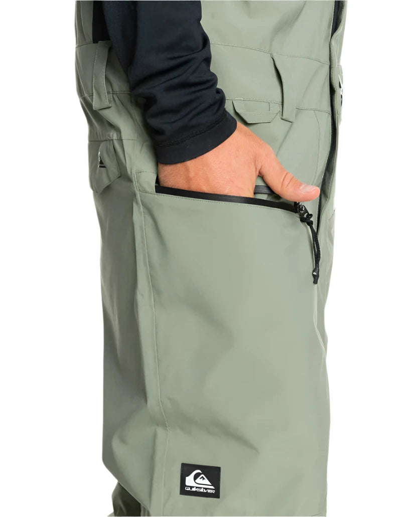 Quiksilver Utility Shell Bib 2025 - Sage green bib with multiple pockets and a black zipper on the right side.
