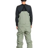 Quiksilver Utility Shell Bib - A pair of olive green snow pants with a black zipper and two zippered pockets on the side.