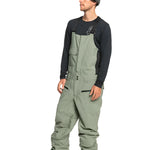 Quiksilver Utility Shell Bib - A pair of olive green snow pants with a zippered pocket on the thigh and adjustable Velcro straps at the waist.