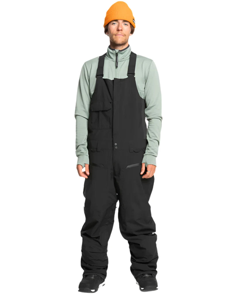 Quiksilver Utility Shell Bib - A black bib-style snow pant with a utility design, featuring multiple pockets and buckles on the side.