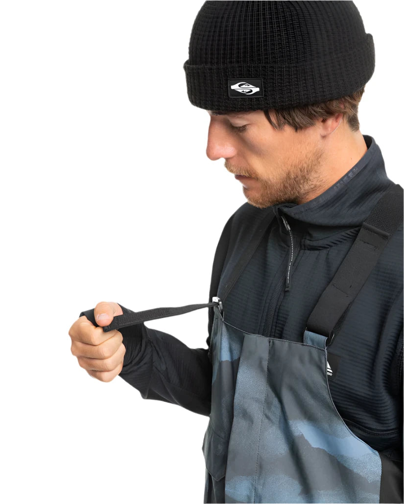Quiksilver Utility Shell Bib - A black bib with a utility-style design, featuring multiple pockets and buckles on the front.