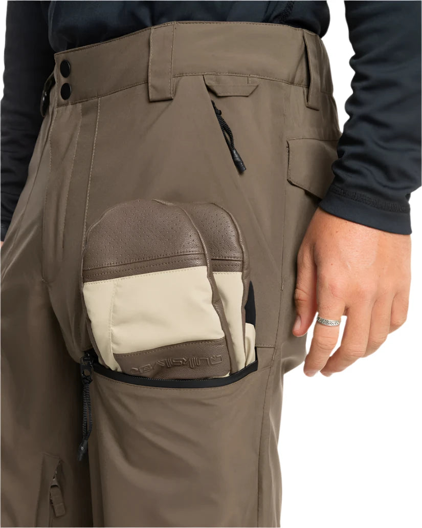 Quiksilver Utility Shell Pant 2025 - A pair of khaki-colored pants with a zippered pocket on the thigh and a black drawstring at the waist.