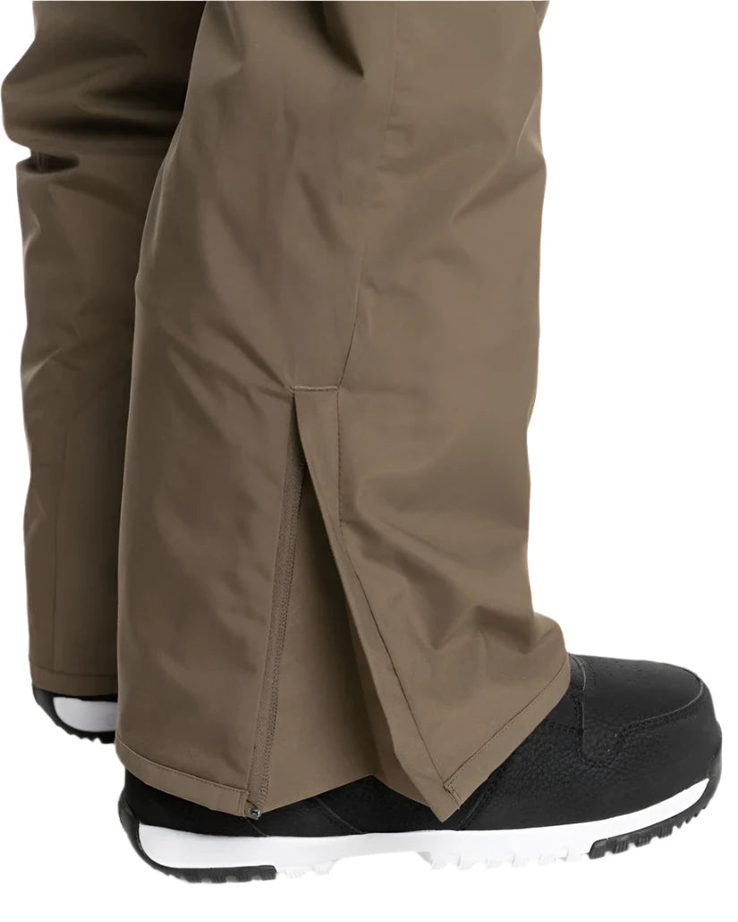 Quiksilver Utility Shell Pant 2025 - A pair of khaki-colored snow pants with a zipper on the left leg.