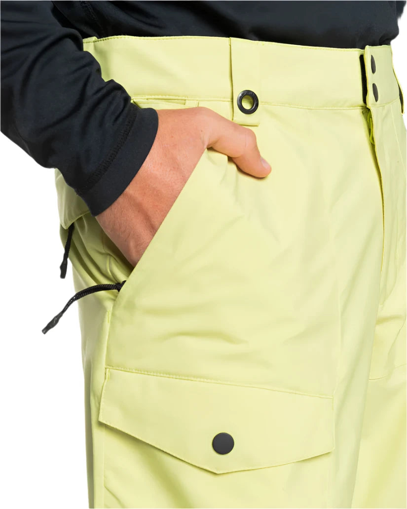 Quiksilver Utility Shell Pant 2025 - A pair of khaki-colored snow pants with a zippered pocket on the thigh and adjustable Velcro straps at the waist.