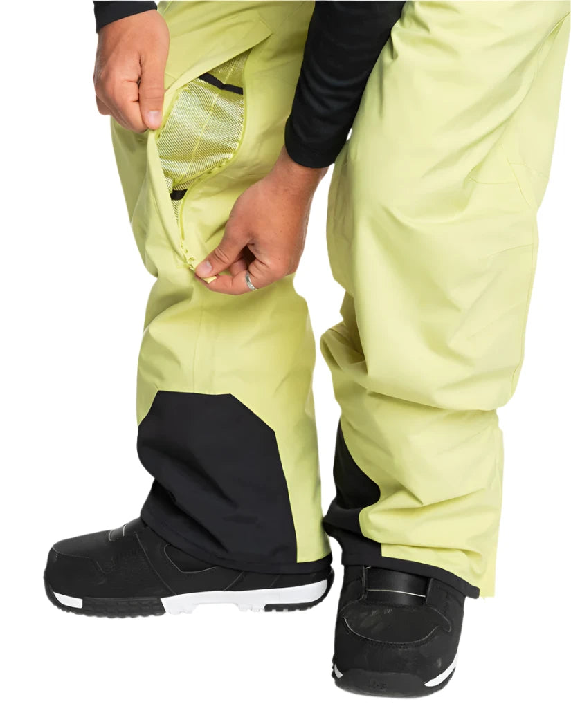 Quiksilver Utility Shell Pant 2025 - A pair of khaki-colored snow pants with a zippered pocket on the thigh and black accents around the ankles.
