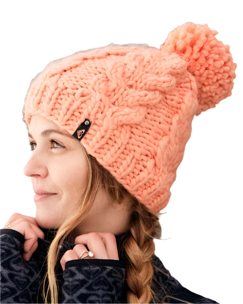 Roxy Women's Winter Beanie 2025 - A light pink beanie with a pom-pom on top.