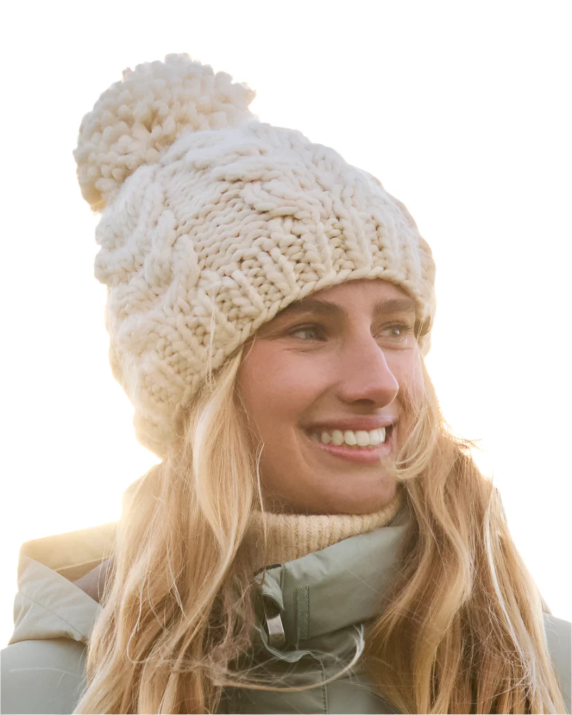 Roxy Women's Winter Beanie 2025 - A cream-colored beanie with a chunky knit pattern and a large pom-pom on top.