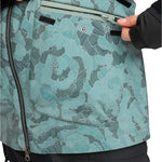 Roxy Women's Stated Insulated Jacket 2025 - A woman wearing a light blue jacket with black stripes and a floral pattern, zipping up the front.