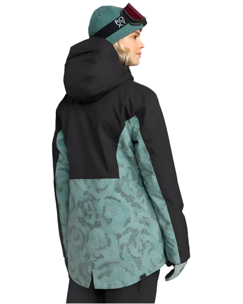 Roxy Women's Stated Insulated Jacket 2025 - A black and teal floral patterned jacket with a hood, worn by a model facing left.