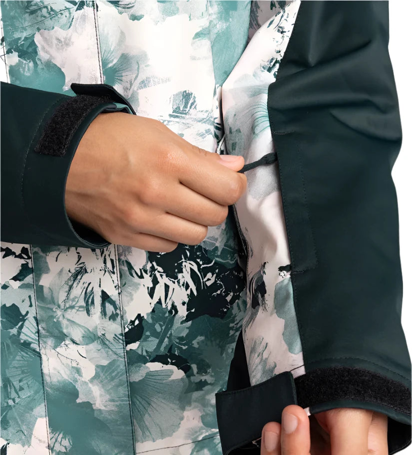 Roxy Women's Jetty 3 In 1 Jacket - A white and teal floral patterned jacket with a black zipper, worn by a model in front of a solid background.