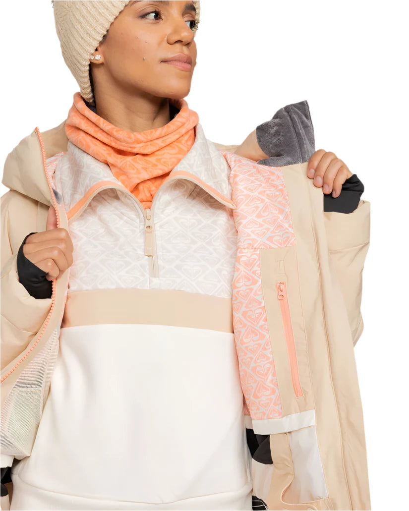 Roxy Women's Alofted Puffy Insulated Jacket - A cream-colored puffer jacket with a zippered front and hood, featuring a geometric pattern on the upper portion of the chest area.