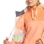 Roxy Women's Meade Insulated Jacket - A peach-colored jacket with a geometric pattern on the upper portion, featuring a zippered chest pocket and a drawstring at the waist.