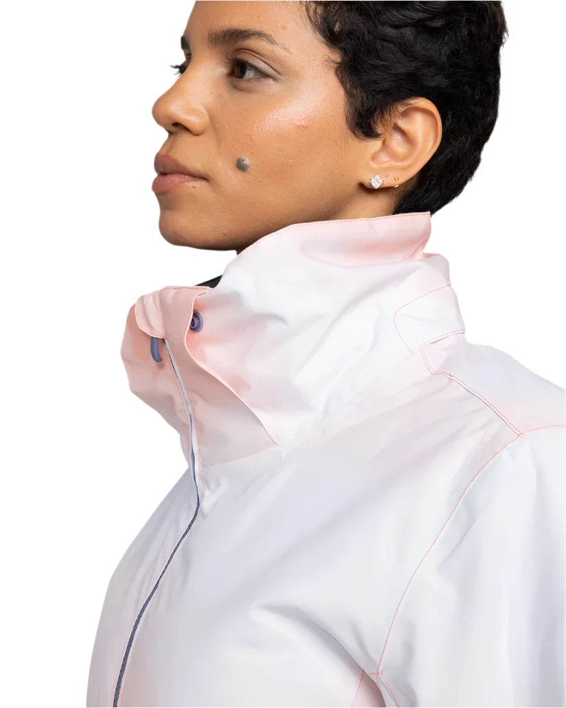 Roxy Women's Jet Ski Insulated Jacket - A woman with short black hair and a mole on her cheek is wearing this jacket, which has a light pink color with darker pink accents around the collar and down the front zipper.