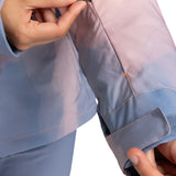 Roxy Women's Jet Ski Insulated Jacket 2025 - A woman wearing a light blue jacket with a zipper on the left side, holding it open to show the inside lining.