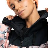 Roxy Women's Presence Insulated Parks Jacket 2025 - A light blue jacket with a white snowflake pattern and black accents, worn by a model posing in front of a snowy mountain backdrop.