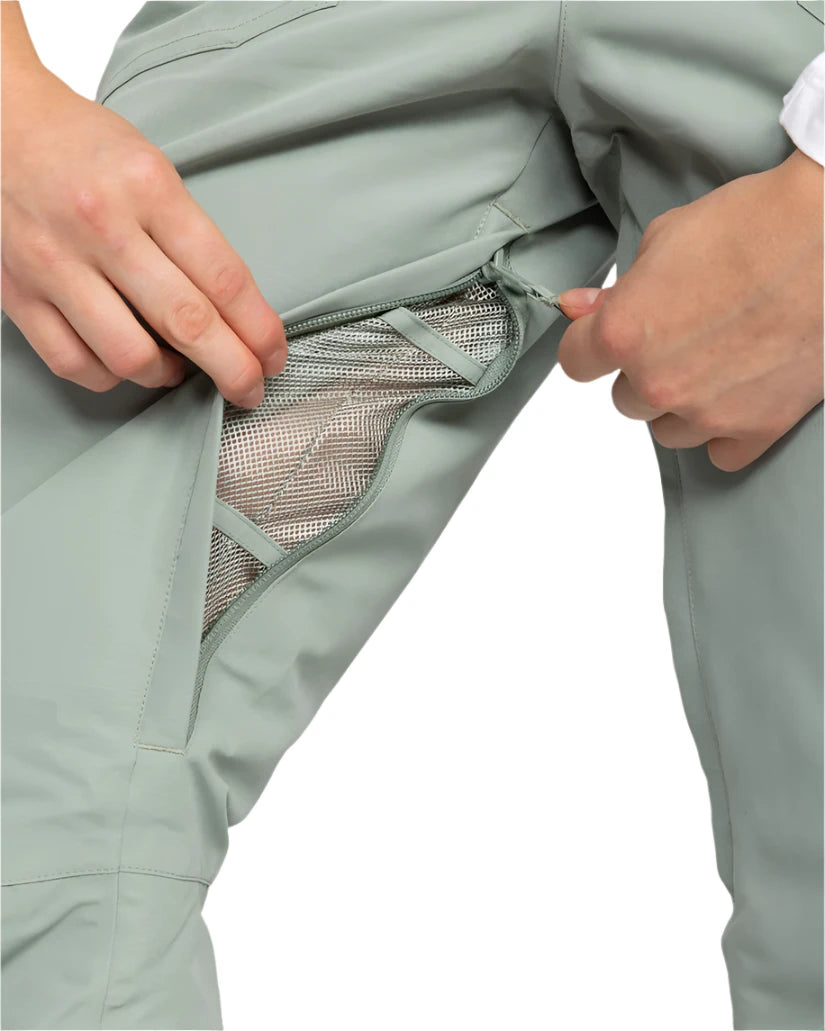 Roxy Women's Rideout Insulated Bib Pant 2025 - A pair of light gray snow pants with a zippered pocket on the right thigh and a small black logo on the left leg.