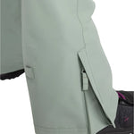 Roxy Women's Rideout Insulated Bib Pant 2025 - A pair of light gray snow pants with a zippered pocket on the side and a small square patch on the left leg.