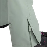 Roxy Women's Rideout Insulated Bib Pant 2025 - A pair of light gray snow pants with a zippered pocket on the side and a small square patch on the left leg.