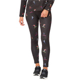 Krimson Klover Women's Multi Skiers Legging - A pair of black leggings with a repeating pattern of skiers in various colors, including red, blue, yellow, and white.